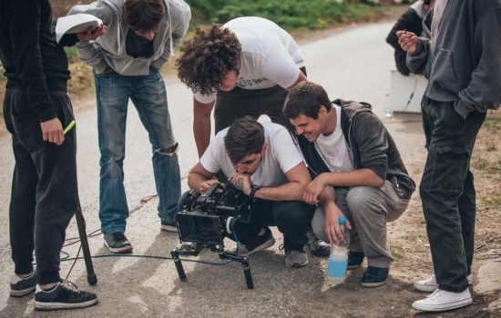 Director and team looking at camera on set